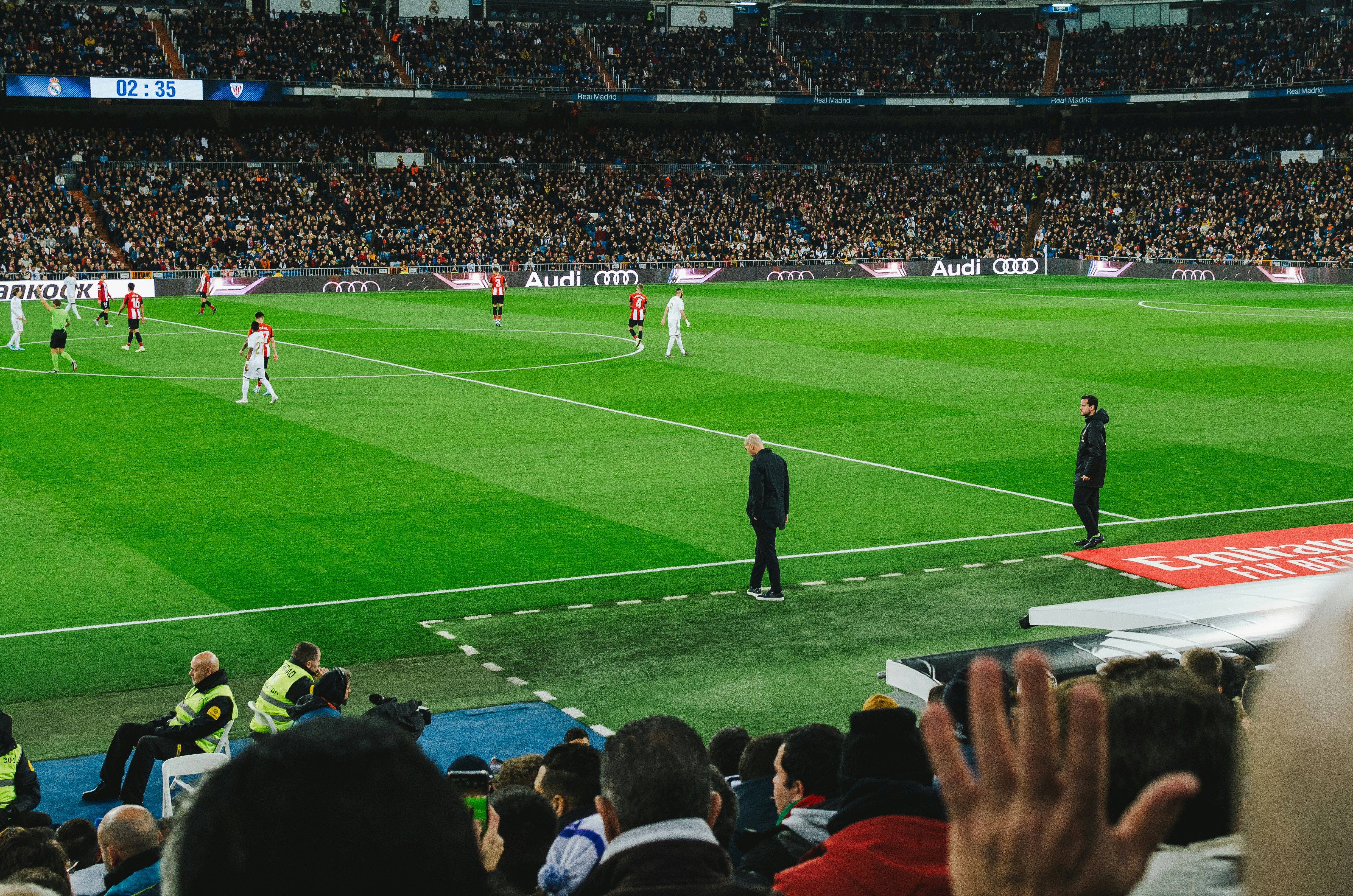 An image of two managers observing a game of football